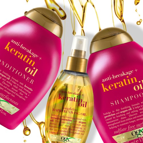 Twee roze flessen en één sprayfles met gouden deksels, allemaal gelabeld keratine olie anti-breukage producten.