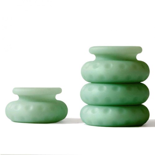 A set of four green, rounded, smooth vases stacked on top of each other and a single one beside them.