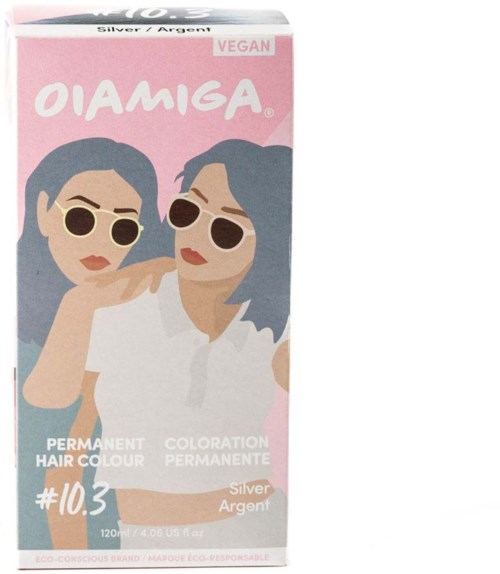 Een doos met veganistische permanente haarkleur, met twee vrouwen met zonnebrillen, één met arm om de andere, roze en wit ontwerp.