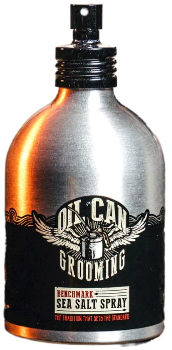 A silver grooming spray bottle with a black label, wings, and the words "Sea Salt Spray" at the bottom.