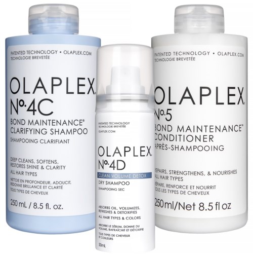 Drie flessen Olaplex haarproducten: shampoo, conditioner en detox, met witte doppen en etiketten.