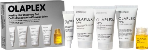 Een set haarverzorgingsproducten van Olaplex, inclusief shampoos, behandelflessen en een gele olie container.