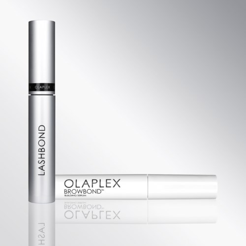 Twee zilveren cilindervormige flessen, één staand en één liggend, gemarkeerd Lash Bond en Olaplex Browbond.
