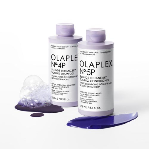 Twee flessen OLAPLEX-haarproducten, een voor blondering, met paarse verf en bellen in de buurt.