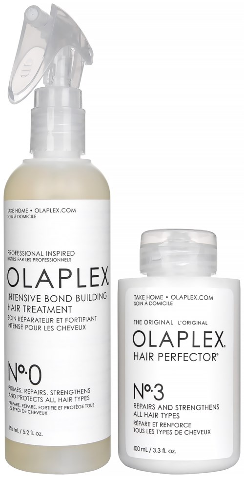 Twee witte flessen met zwarte tekst, een spray en een dop, voor haarbehandeling en versterking. Gemakkelijke leesbare labels.