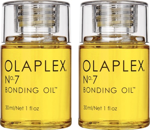 Twee kleine flessen Olaplex No.7 Bonding Oil met gele vloeistof. Clear doppen en zwart tekst op de flessen.