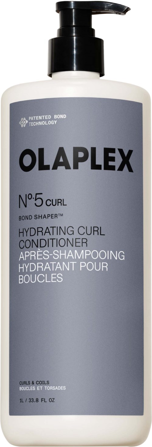 Pitkä valkoinen pullo mustalla pumpulla, merkiltään Olaplex No.5 Curl Hydrating Curl Conditioner.