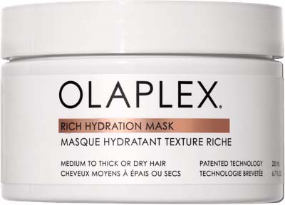 Een witte doos met een label die zegt 'Olaplex Rich Hydration Mask' voor dik of droog haar, hint naar haarverzorging.