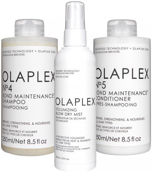Three hair care bottles and one spray in the center, labeled for shampoo, conditioner, and nourishing spray.