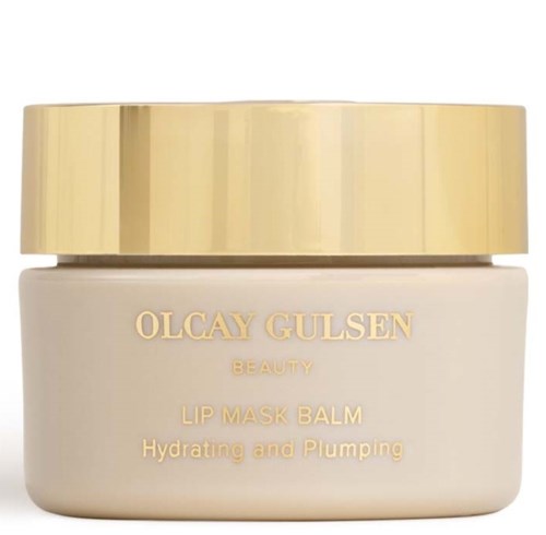 Een beige pot met een gouden deksel, gemerkt "OLCAY GULSEN BEAUTY LIP MASK BALM Hydrating and Plumping."