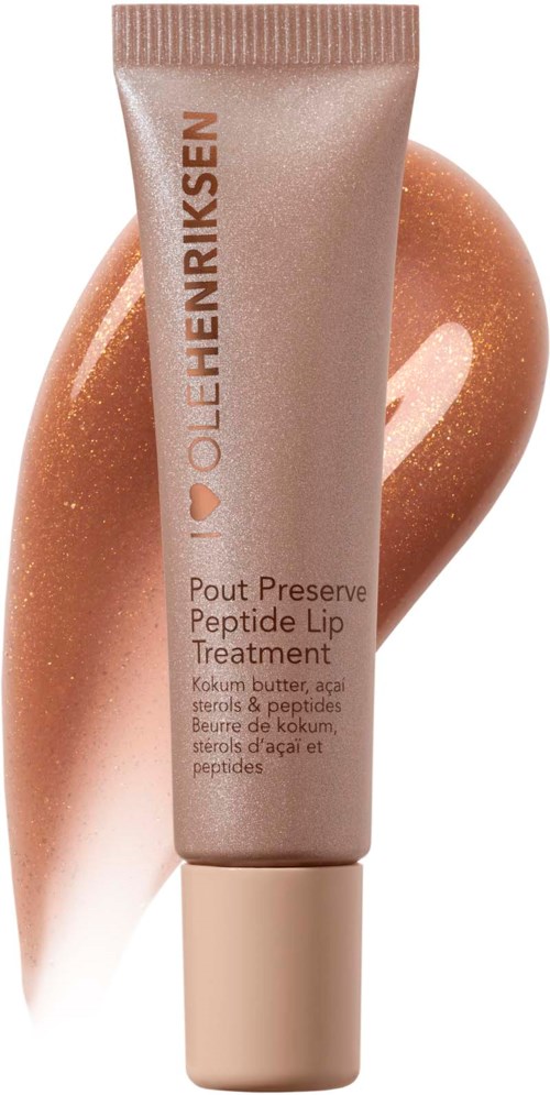 Eine Tube mit Lippenpflege, dahinter ein peachfarbenes Muster und Text auf der Tube.