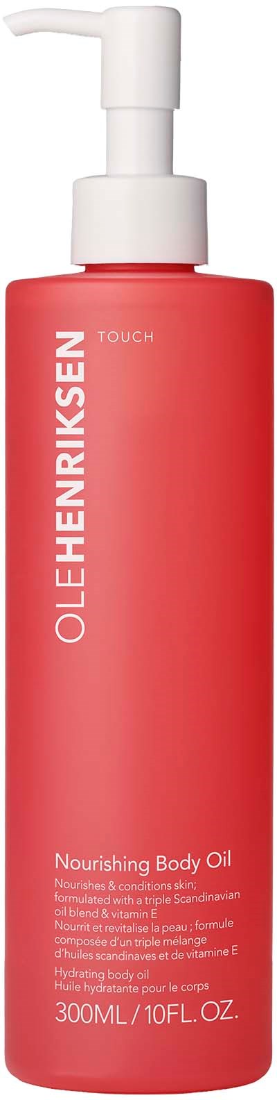 A red bottle with a white pump labeled 'Ole Henriksen' and 'Nourishing Body Oil,' containing 300ml.