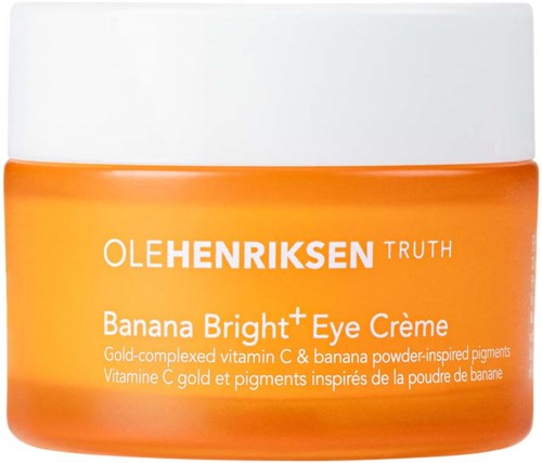 Oranje container met witte deksel, gelabeld als Ole Henriksen Banana Bright Eye Creme, wat erop wijst dat het een huidverzorgingsproduct is.