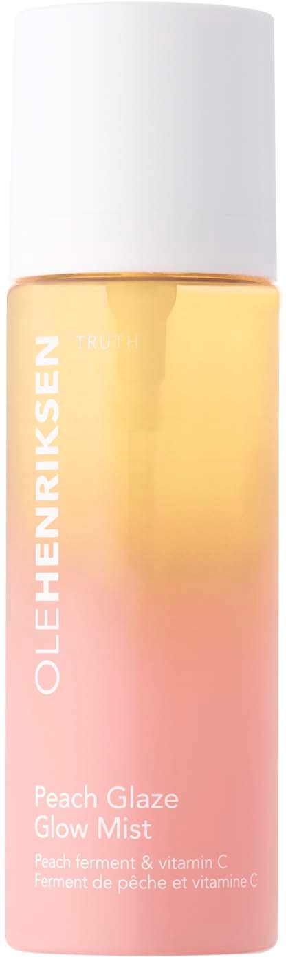 Een sprayfles met roze en gele gradient, gemarkeerd Ole Henriksen Peach Glaze Glow Mist.