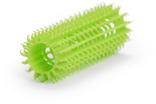 A bright green plastic cylindrical cleaning tool with many small spiky brushes. It is used for cleaning bottles or narrow spaces.