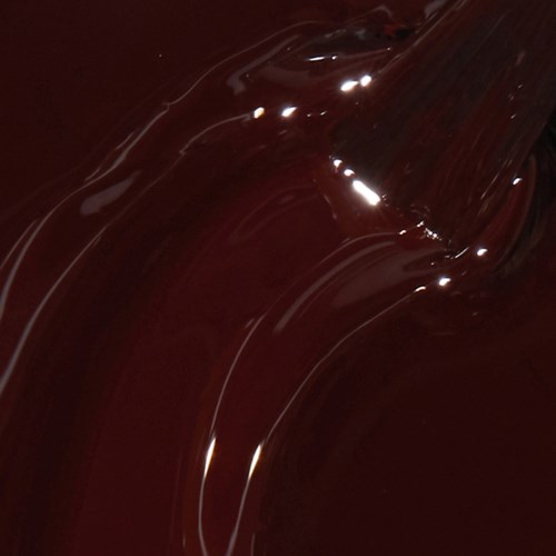 Dark, glossy, melted chocolate with shiny, wavy texture.