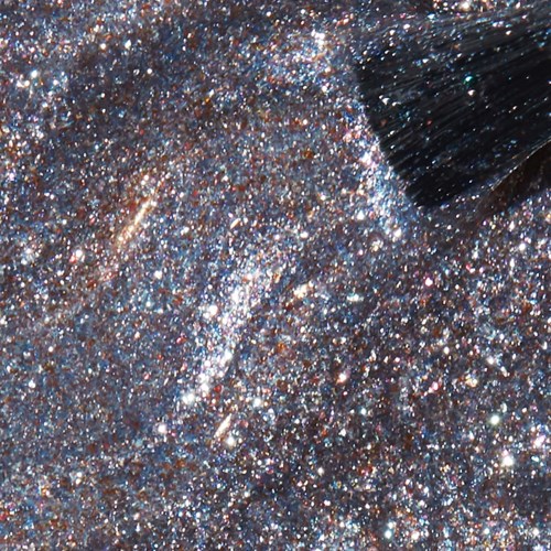 A person wearing shiny, metallic clothing with lots of glitter and sparkles.