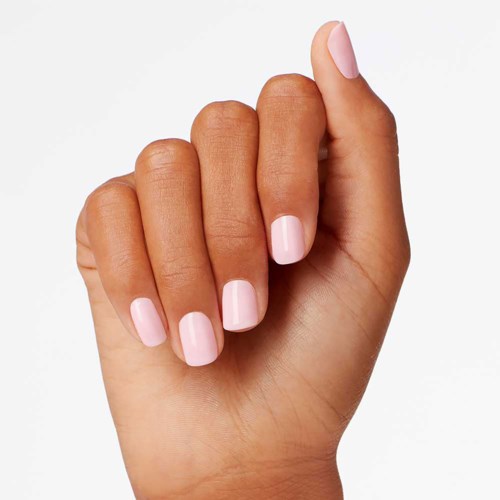 Close-up of a hand with light pink nails, fingers slightly curled, clean and well-groomed.