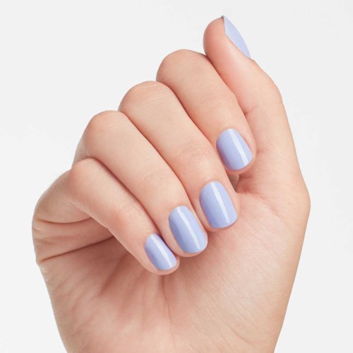 A hand with nails painted in light purple color, shown against a plain background.