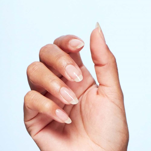 A hand with neatly painted long nails against a light background.