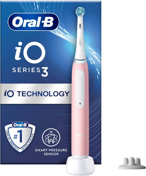 A pink electric toothbrush in front of its blue box and three white brush heads. The box has the brand Oral-B and iO Series 3.
