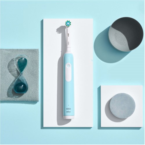 A blue electric toothbrush is centered, with an hourglass and round containers on a light blue background.
