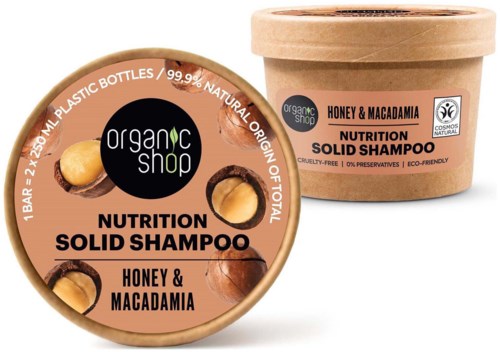 A round jar and a cardboard container of organic honey and macadamia solid shampoo. The labels are beige with black and brown text.