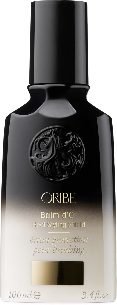 Eine schwarze und beige Sprühflasche mit goldenen Akzenten, gekennzeichnet mit ORIBE Balm d'O Heat Styling Shield, 100 ml.