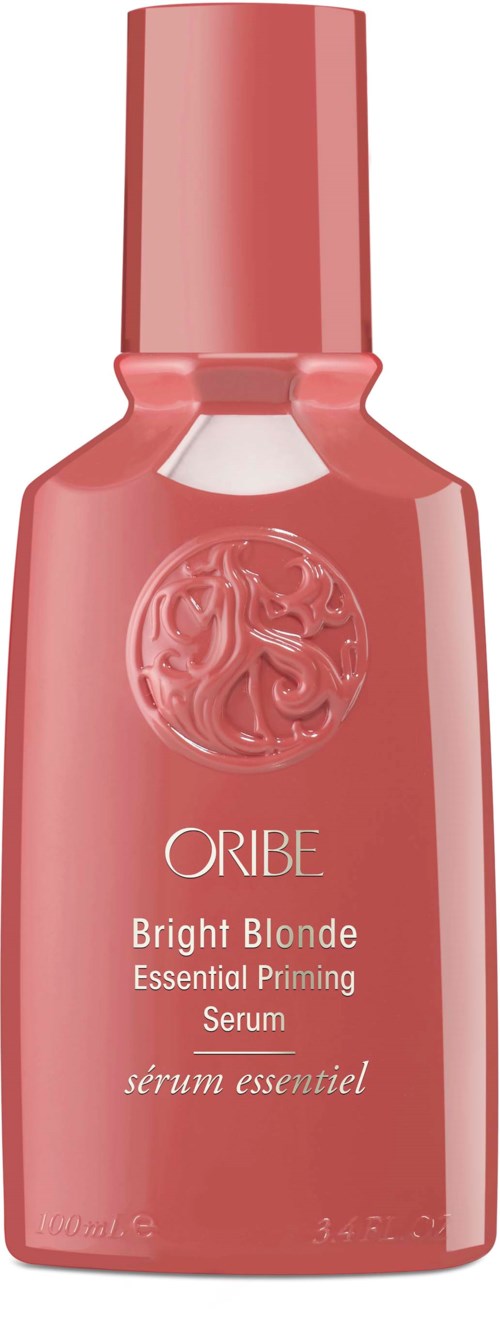 Vaaleanpunainen pullo Oribe Bright Blonde -hiusseerumilta, jossa lohikonlogo ja valkoinen teksti.