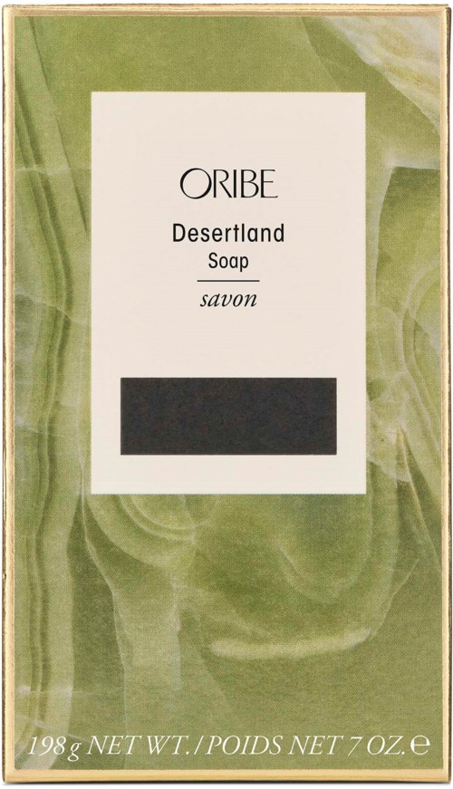 Eine Seifenbox mit der Aufschrift 'Oribe Desertland Soap' in Grün und Weiß, Gewicht und schwarzem Bereich für Barcode.