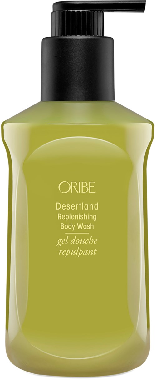 Eine grüne Körperwaschflasche mit schwarzem Pumpkopf, gekennzeichnet als desertland replenishing body wash.