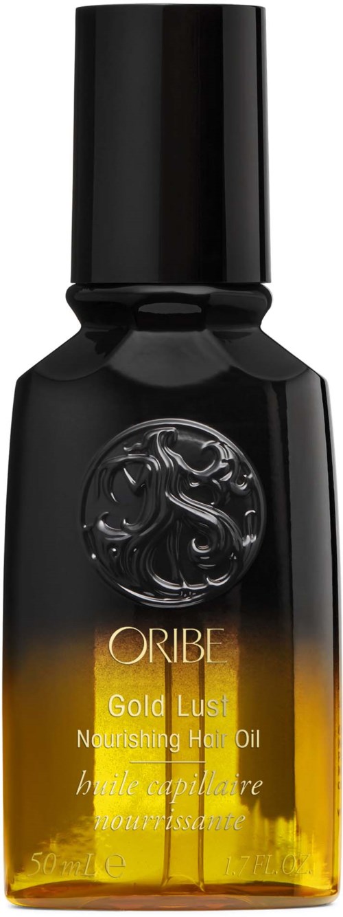 Eine kleine schwarze und goldene Flasche mit Haöl von Oribe, labeled 'Gold Lust.'