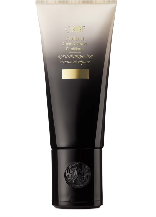 Ein schwarzer und goldener Tube mit der Aufschrift ORIBE Gold Lust Repair & Restore Conditioner und einem Logo unten.