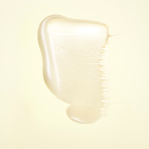 A blob of creamy white liquid with a smooth top and slight ridges on the side.