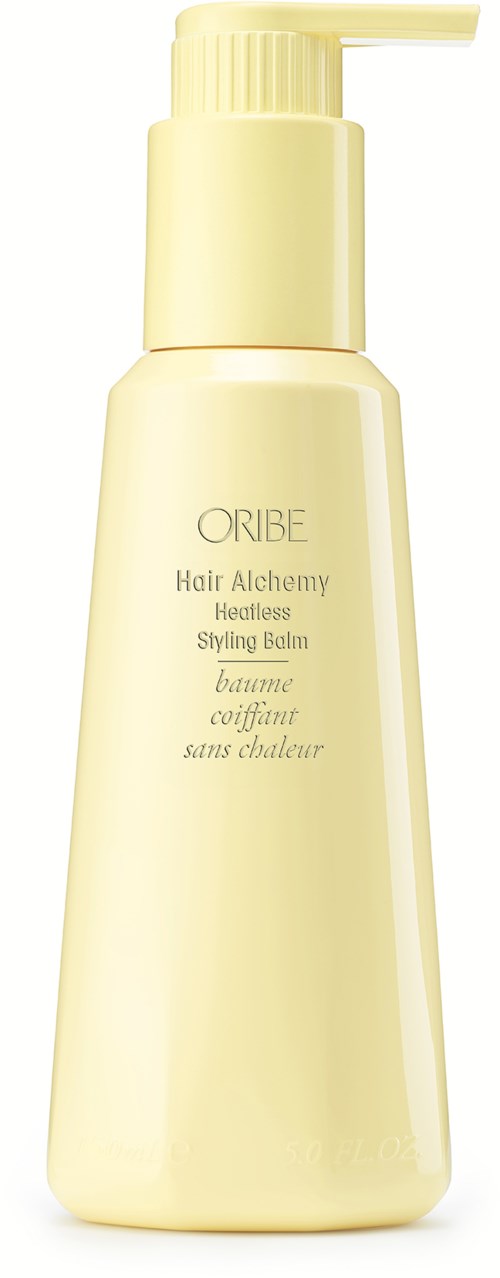 Een lichtgele fles met pomp, gelabeld 'ORIBE Hair Alchemy' voor haarstyling en verzorging.