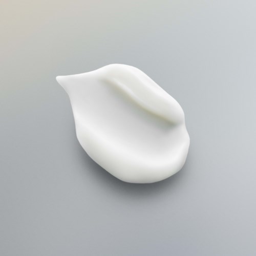 Ein weißes, glattes, curved Objekt mit einem kleinen Buckel auf einer grauen Oberfläche.