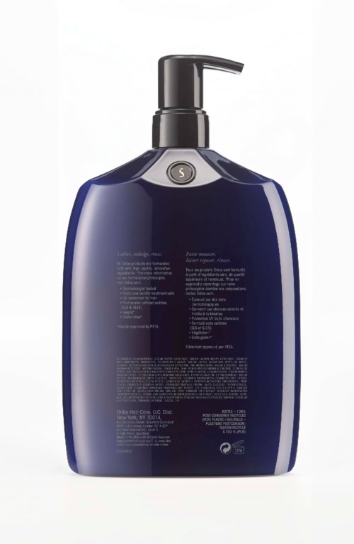 Blauartige Lotionflasche mit Text und kleinem Kreis oben, vor weißem Hintergrund.