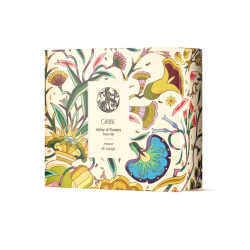 Bunte Verpackung für Reisen set mit Blumenmuster und Oribe-Marke, Text 'Valley of Flowers'.