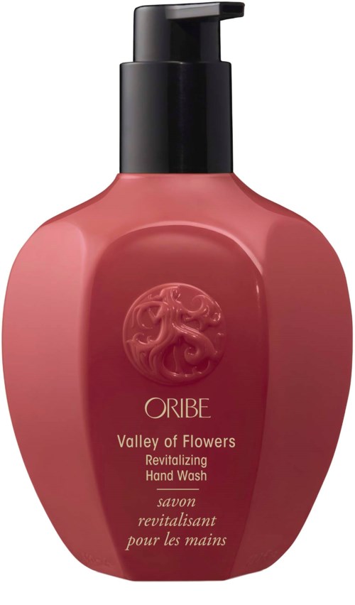 Eine rosa Handwaschflasche mit schwarzem Pumpkopf, Logo und Text zu revitalisierender Handwäsche.