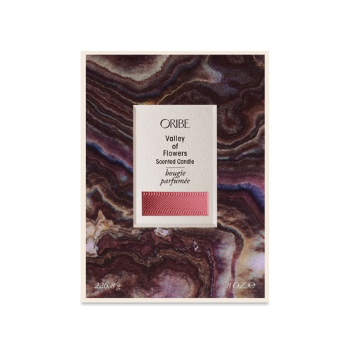 A box for scented candles with a marble-patterned design and a label that says 'Valley of Flowers'.