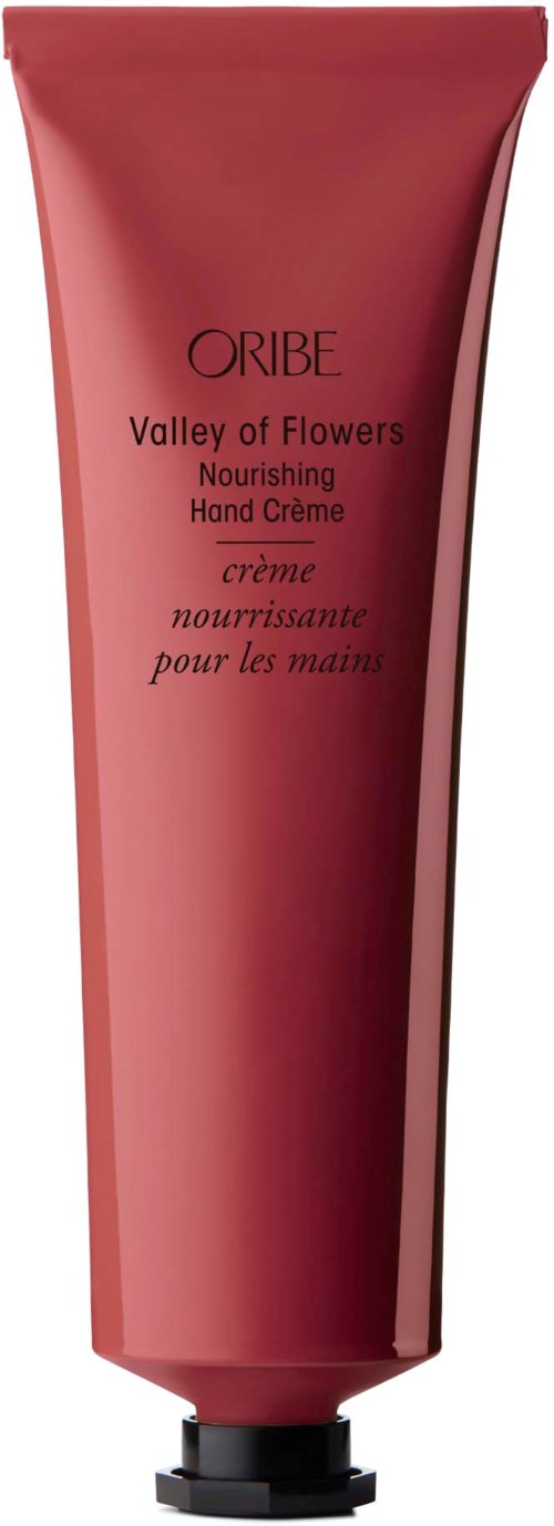 Eine pinke Tube Oribe Valley of Flowers pflegende Handcreme mit schwarzem Deckel.