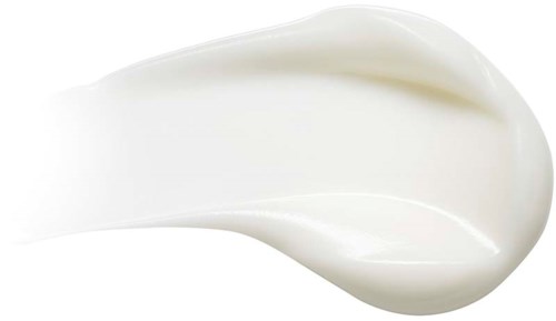 Et hvitt, kremaktig stoff i en buet form, sannsynligvis lotion eller krem på svart bakgrunn.