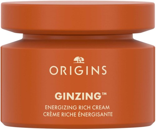 Orangerne Glas mit weißen Text, beschriftet 'ORIGINS GINZING,' ein Hautcreme, mit einem kleinen Baumlogo darüber.