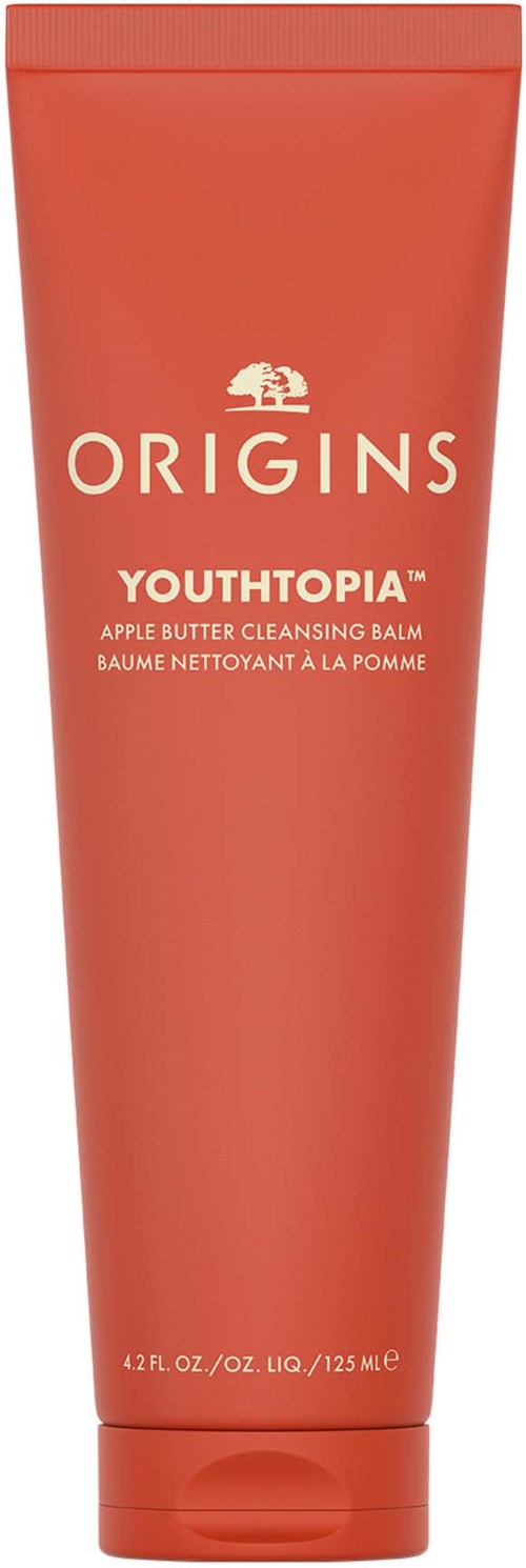 Persikanvärinen putkiloväri, jossa lukee 'Origins Youthtopia Apple Butter Cleansing Balm'.
