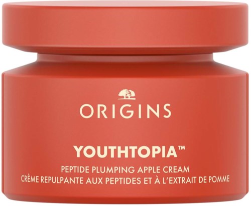 A red jar of skincare cream labeled 'Origins Youthopia' for face, with gold writing and a simple design.