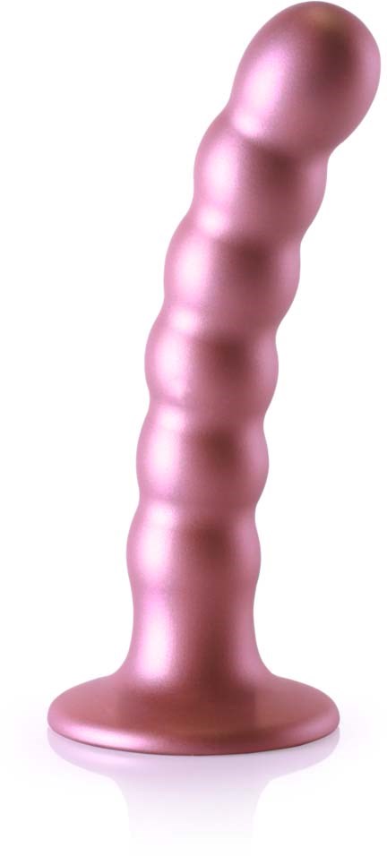Ein rosa, gerillter, zylindrischer Gegenstand, der aufrecht mit einer runden Basis steht.