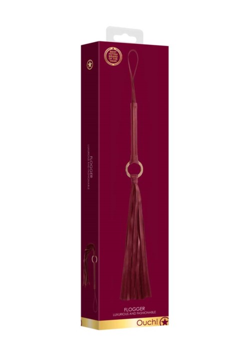 Langer Quasten-Schlüsselanhänger mit Schlaufe in lila Box, beschriftet 'Flogger'.