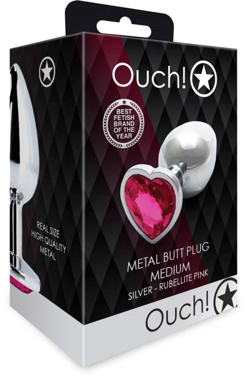 Ein metallischer Afterplugg mit rotem Herz, mittlere Größe, mit 'Ouch!' auf schwarzer Verpackung.