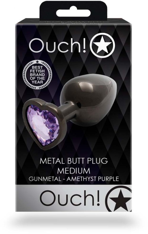 Ein Metall-After-Als-Artikel mit einem violetten Herz-förmigen Edelstein, verpackt in einer schwarzen Schachtel, mit 'Ouch!' und 'Medium' beschriftet.