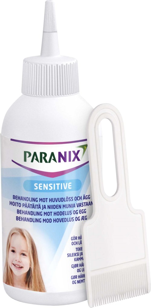 A bottle of Paranix Sensitive treatment for head lice and eggs with a comb beside it.